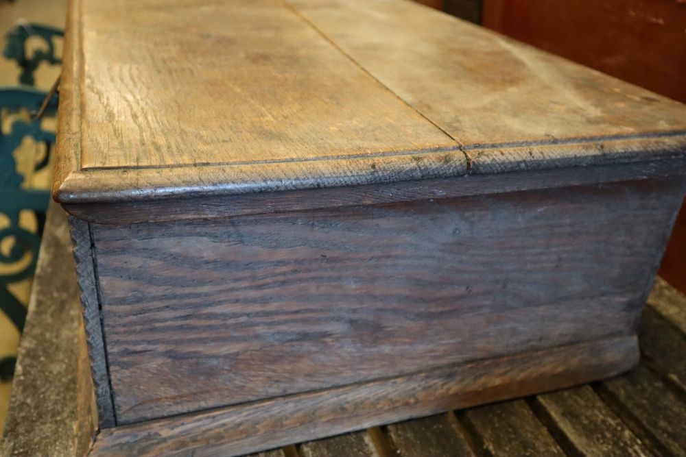 A 17th century carved oak bible box, width 63cm